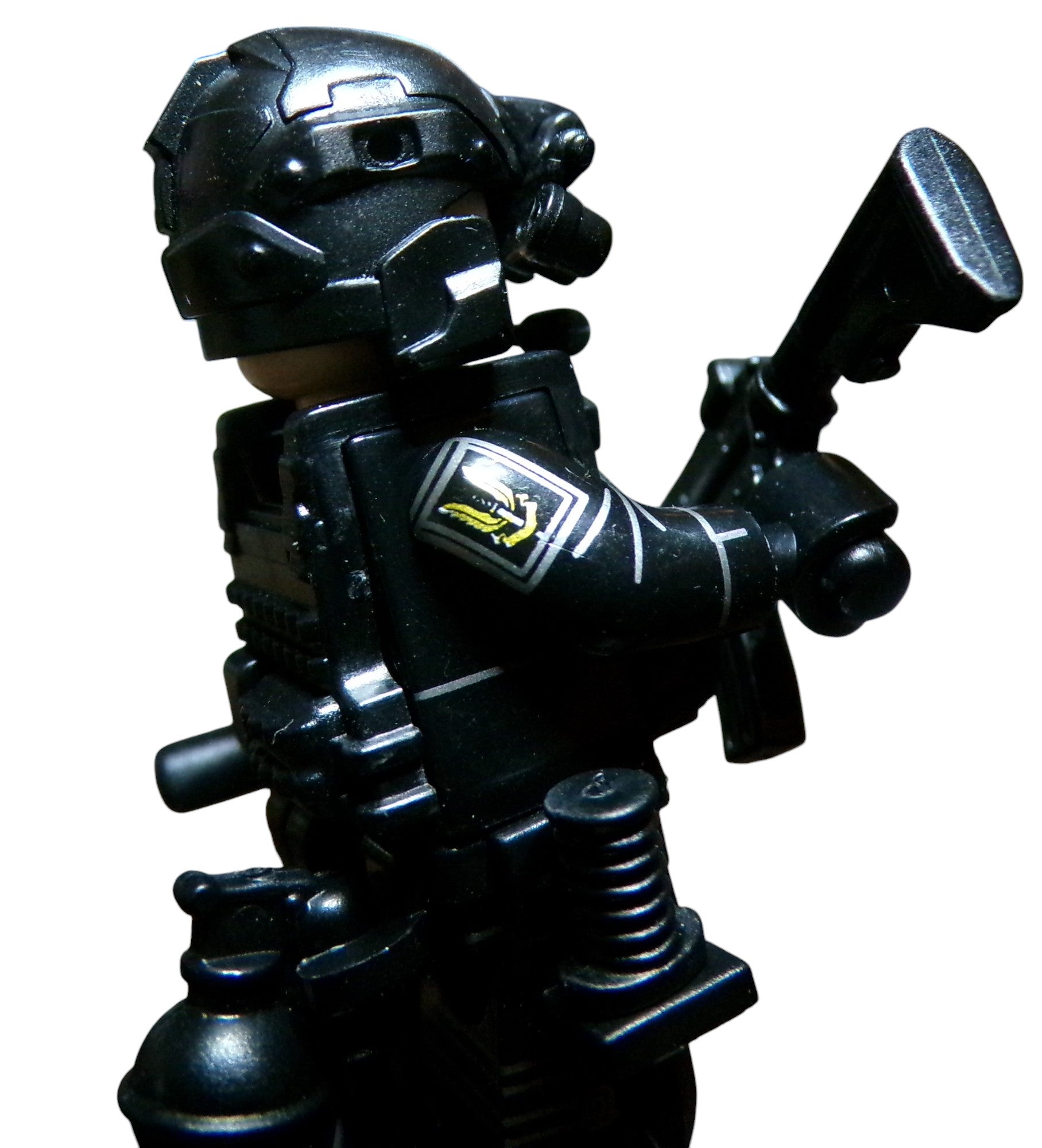 A LEGO Special Forces minifigure, resembling SAS operatives, is equipped with tactical gear and a helmet. Sporting body armor, weaponry, and a shoulder emblem, it captures the essence of elite special forces units like KSK and Navy SEALs.