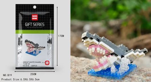 The left side displays the package of a Mini Nano Micro Diamond Animal Building Blocks set, measuring 17 cm high and 25 cm wide. The right side shows the assembled shark on a rock, featuring an open mouth and detailed teeth made from nano micro diamond blocks.