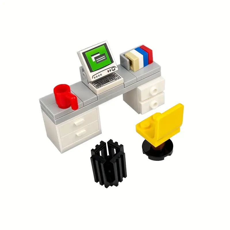 The Minifigure Computer Desk Furniture set features building blocks that create a modern home office scene, complete with a desk and drawers, computer with a green screen, red mug, books, yellow swivel chair, and black cylindrical trash can.