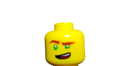 Close-up of a smiling LEGO 6191962 Minifigure Head featuring a dual-faced yellow design with green eyes and reddish eyebrows, including a playful raised eyebrow, set against a white background.