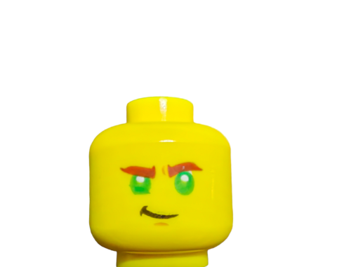 Close-up of the LEGO 6313216 Minifigure Head, Double Face Green Eyes - UB1022, showing a yellow figure with striking green eyes, brown eyebrows, and a small smirk against a plain white background.