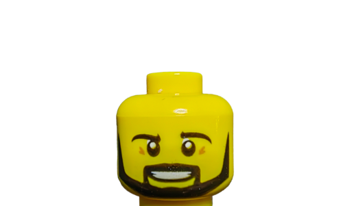 A close-up of the LEGO 6112620 Minifigure Head showcases a smiling yellow face with a black beard and rosy cheeks, set against a white background.