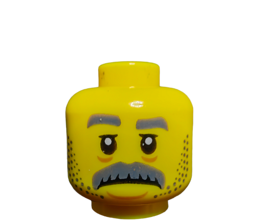 The LEGO 6289787 Minifigure Head features a serious expression with gray eyebrows, a mustache, stubble, and large forward-looking eyes. This yellow head stands out against a plain white background, capturing the essence of iconic minifigures.