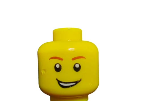 Close-up of the LEGO 4570043 Minifigure Head, Male Reddish Brown Eyebrows - UB1072, featuring black eyes with white pupils and a smiling face. Its flat top connects with other pieces, and a plain white background highlights the expressions.