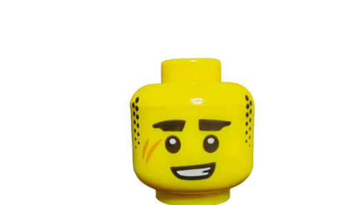 The LEGO Minifigure Head, UB1492, is yellow with black freckles, large eyes, bushy black eyebrows, facial scratches, and a wide smile. It boasts a small rectangular top for attachment. Its both a fun accessory and a sought-after collectors piece that stands out in any collection.