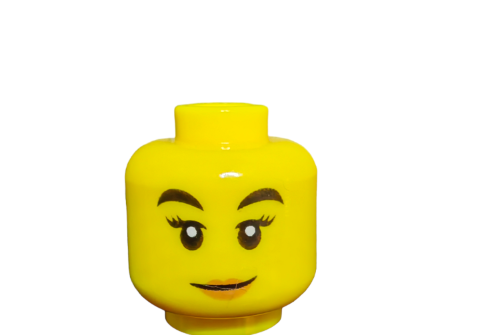 The LEGO 6288016 Minifigure Head features dual-sided designs: a smiling face with bold black eyebrows, peach lips, and large eyes with eyelashes on one side, and a playful black mask pattern on the other.