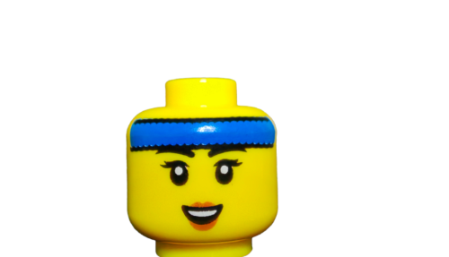 Close-up of the LEGO 6419101 Minifigure Head, featuring dual sides with a smiling face, black eyebrows, eyelashes, blue headband, and black hair details on a white background.