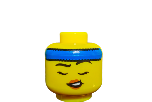 The LEGO 6419101 Minifigure Head, UB1390, is dual-sided with a yellow face, closed eyes, a smile, and black eyebrows. It features eyelashes and a blue headband against a plain white background—ideal for imaginative play.