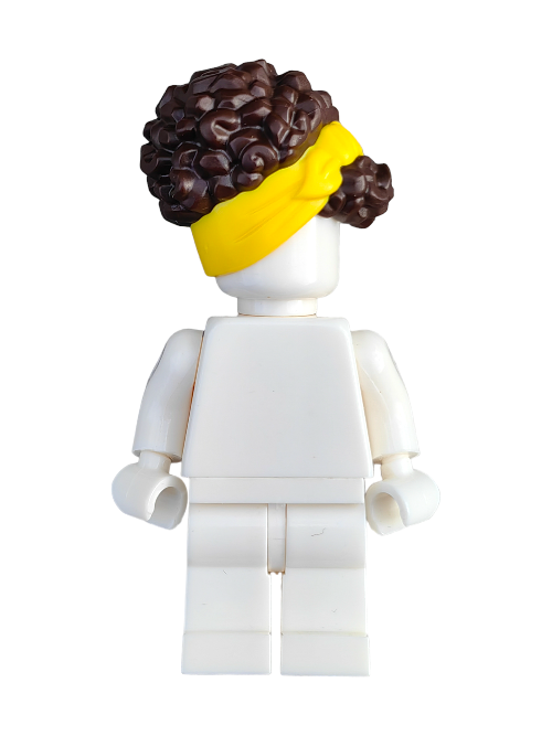 A white LEGO minifigure with curly brown hair styled using the LEGO 6361359 Wig, featuring a yellow head wrap, has its back turned to the viewer, adding intrigue and making it a perfect addition to any toy collection.