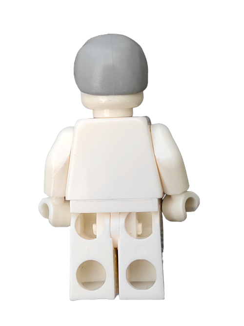 Back view of the small, white LEGO 4211740 figurine featuring block-like limbs and a smooth, gray helmet accessory, standing upright.