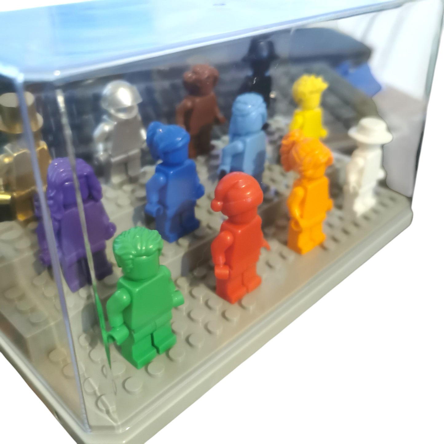 The Vibrant Colour Minifigures with Display Case features twelve eye-catching figures that stand on LEGO baseplates, adding vivid hues to your display in a transparent case.