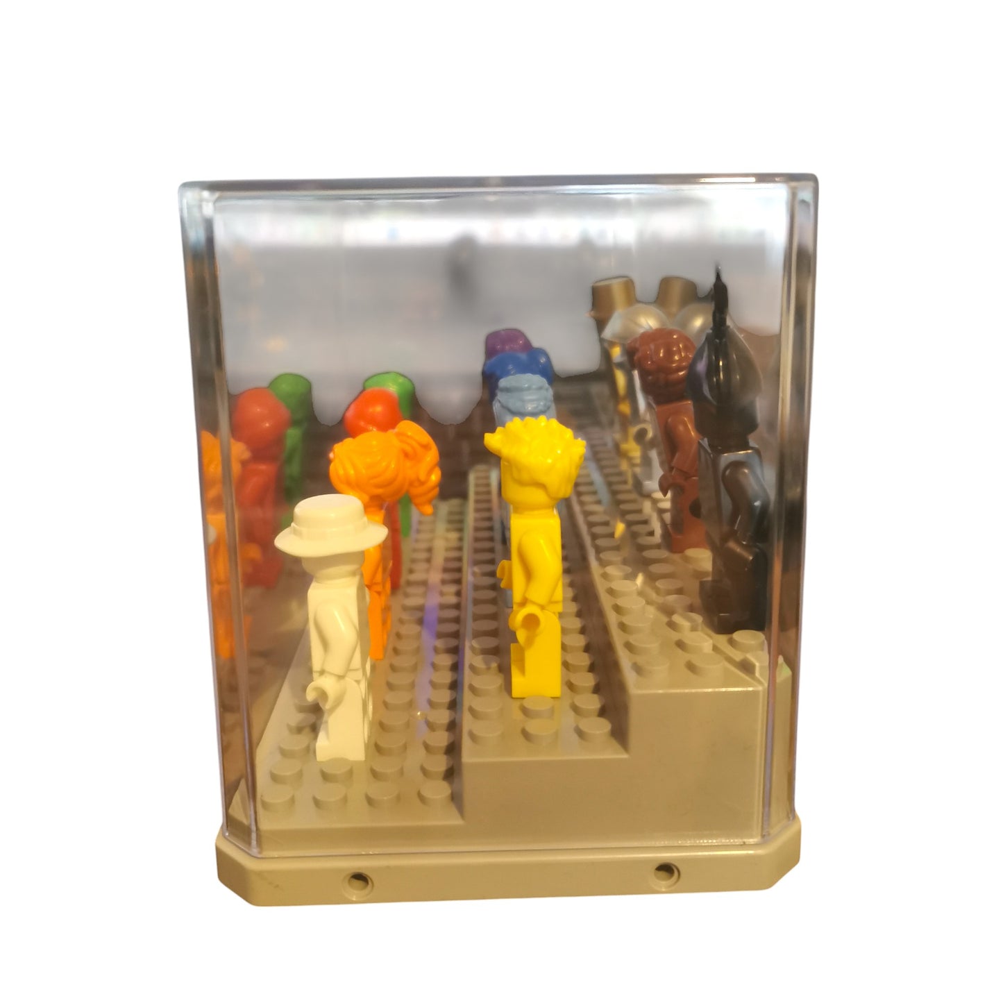 The Vibrant Colour Minifigures with Display Case includes 12 brightly colored minifigures in hues like orange, yellow, blue, and purple. They are arranged in rows facing forward within a clear, rectangular display case.