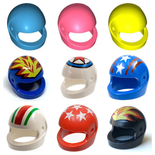 Nine vibrant motorcycle helmets for minifigures are displayed in a grid, offering solid blue, pink, and yellow options, as well as red, blue, and white designs featuring stars, stripes, flames, and geometric patterns.