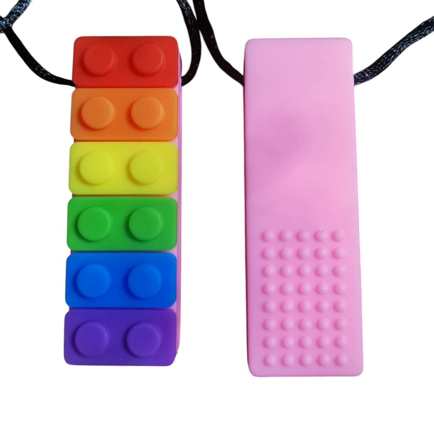 Displayed are two silicone sensory chew necklaces: a vibrant rainbow interlocking brick design and a solid pink with dotted texture, both serving as oral sensory aids for children with ADHD and autistic needs, suspended on black cords.
