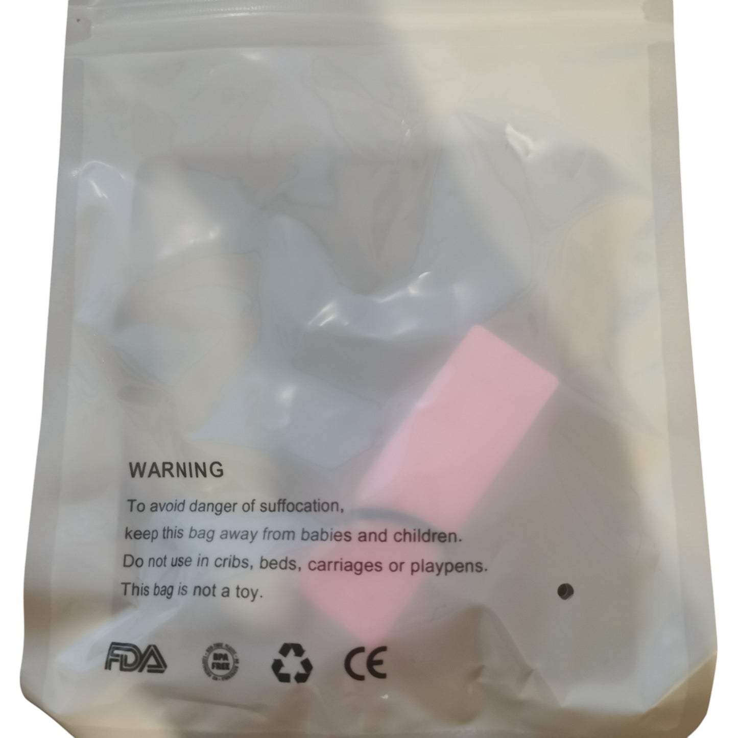 A translucent plastic bag with a suffocation warning encases a pink Sensory Chew Necklace Rainbow Chew Toy for children with ADHD. This is not a toy and should be out of childrens reach. Certified safety symbols are printed on the bottom for reassurance.
