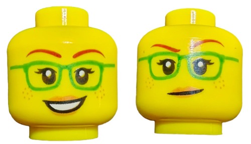 The yellow LEGO 6271746 Minifigure Heads feature green glasses and red eyebrows, with one side smiling warmly and the other showing a mischievous smirk. Freckles on both sides add charm to these dual-sided expressions.