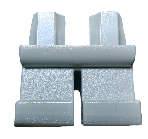 A close-up of the SHORT LEGS product shows a grey, rectangular plastic object with two vertical protrusions and a horizontal bar at the top, resembling a minimalist wall plug or bracket. The surface is smooth against a white background.