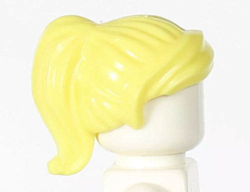 A LEGO minifigure with the LEGO 6092833 Wig, Yellow Hair Long and Wavy with Ponytail - UB1345 appears against a plain white background. The figure has no visible facial features, creating potential for imaginative play.