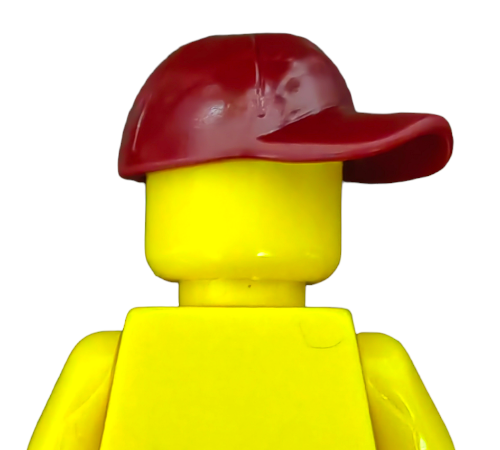 A LEGO 6102964 character, featuring a bright yellow minifigure head and torso, wears a distinctive dark red cap tilted to the side. This highlights the creative potential of interchangeable parts.