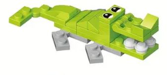 The 12 Brick Block Forest Animals set includes a playful small green and yellow toy crocodile made from interlocking bricks, featuring gray legs, white teeth, large cartoon eyes, and a charming expression for endless playtime fun.