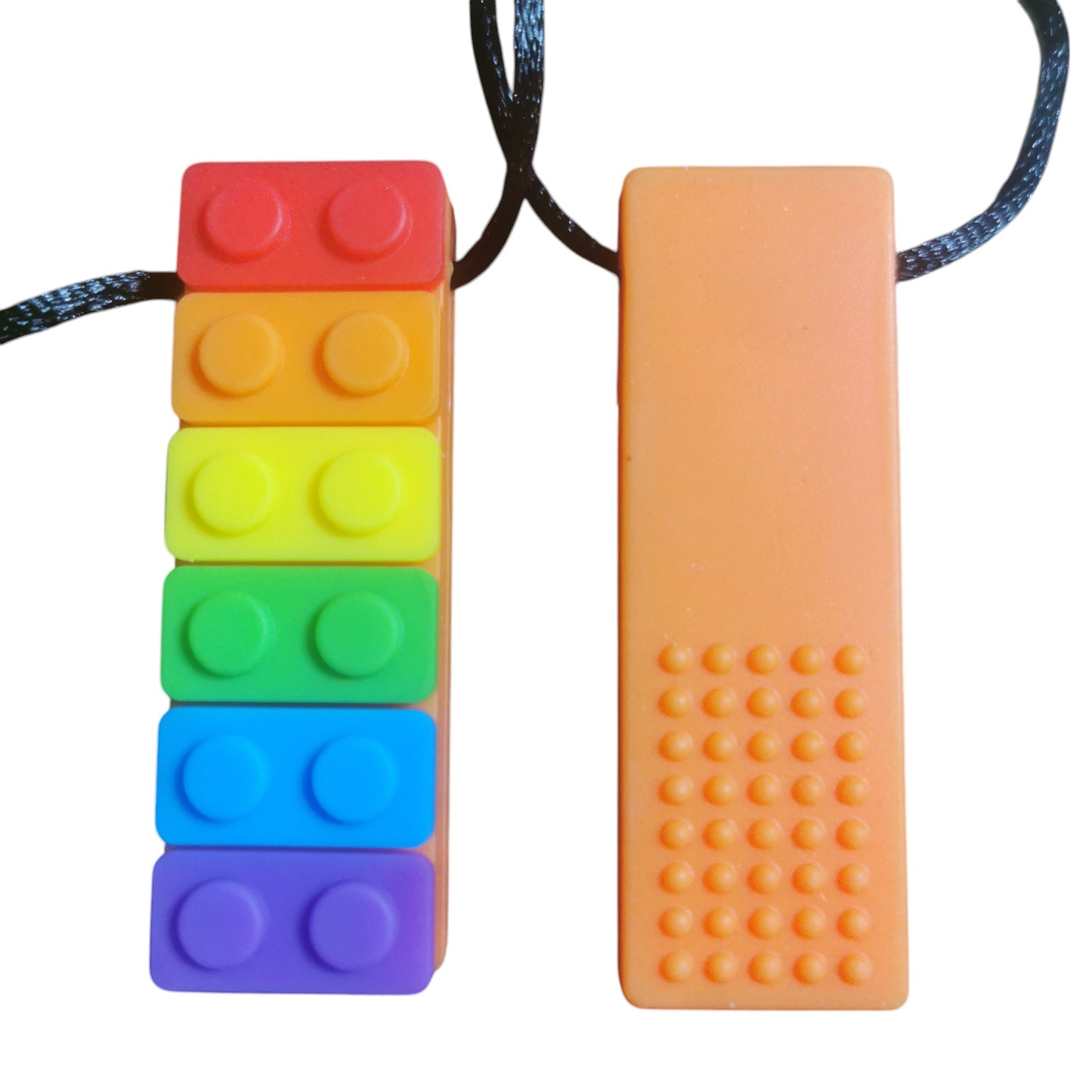 Two Sensory Chew Necklaces are shown on a white background: one is the Rainbow Chew Toy resembling rainbow building blocks, and the other is an orange oral sensory aid with raised bumps. Both have black cords for easy wear.