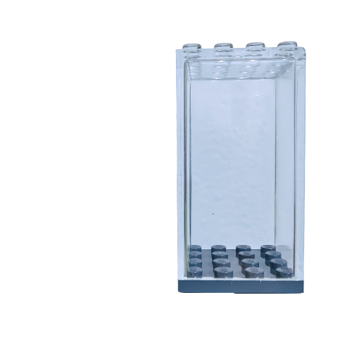 A Small Minifigure Display Case, featuring a transparent rectangular plastic design with visible studs on top and a grid-like pattern on the bottom, stands against a plain white background.