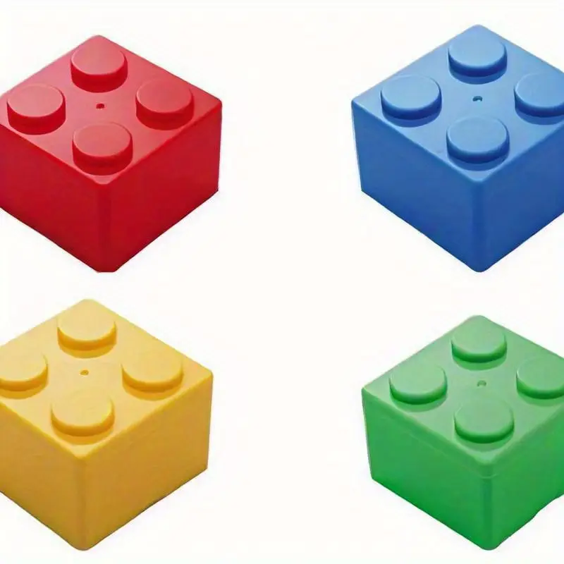 Four vibrant Pack of 4 2x2 Building Block Storage Containers in red, blue, yellow, and green are displayed against a white background. Each container features four studs on top, resembling large interlocking LEGO pieces.