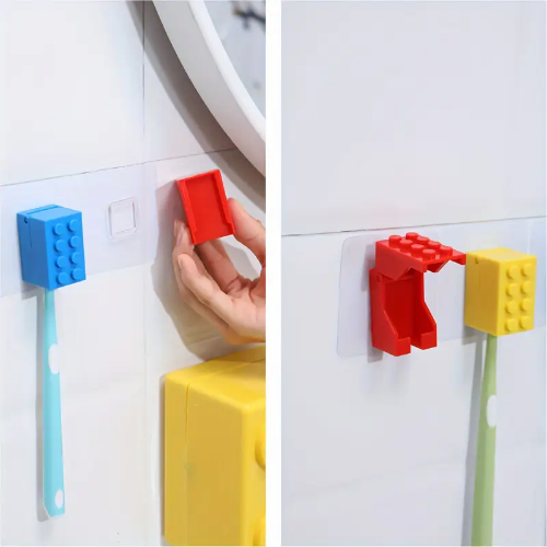 Two images display the Kids Childrens Toothbrush Holder Wall-Mounted Brick Blocks Style, shaped like interlocking bricks. On the left, a hand mounts a blue holder with a toothbrush below; on the right, it arranges red and yellow holders. Made from durable plastic, these add fun and function to any space.