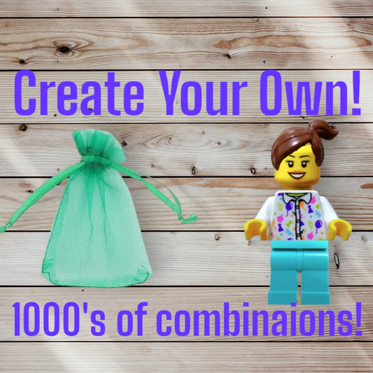 A wooden surface features a LEGO Minifigure with brown hair, a printed top, and blue pants next to a green mesh bag. Purple text states Personalised LEGO® - Design a Minifigure with gift bag. 1000s of combinations, sparking endless design possibilities and creativity.