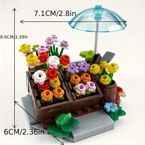 The Minifigure Flower Cart Plant Bouquet Building Blocks Set emulates a Plant Bouquet with vibrant blooms in wooden crates on a stone platform. Completed by a small blue umbrella, it measures 7.1cm wide, 8.6cm tall, and 6cm deep, making it an enchanting addition to any space.