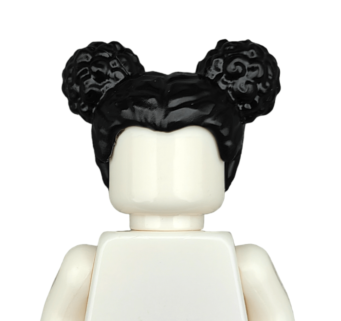 A close-up of the LEGO mini-figure from BLACK WIGS, showcasing a smooth, featureless white face and black hair styled into two curly buns, with no clothing details.