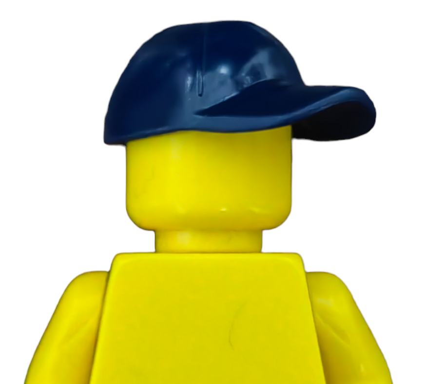 A yellow plastic figurine with a smooth head and no face, wearing a dark blue baseball cap tilted to the side, is seen against a plain white background. Product: PRODUCT HATS AND HOODIES.