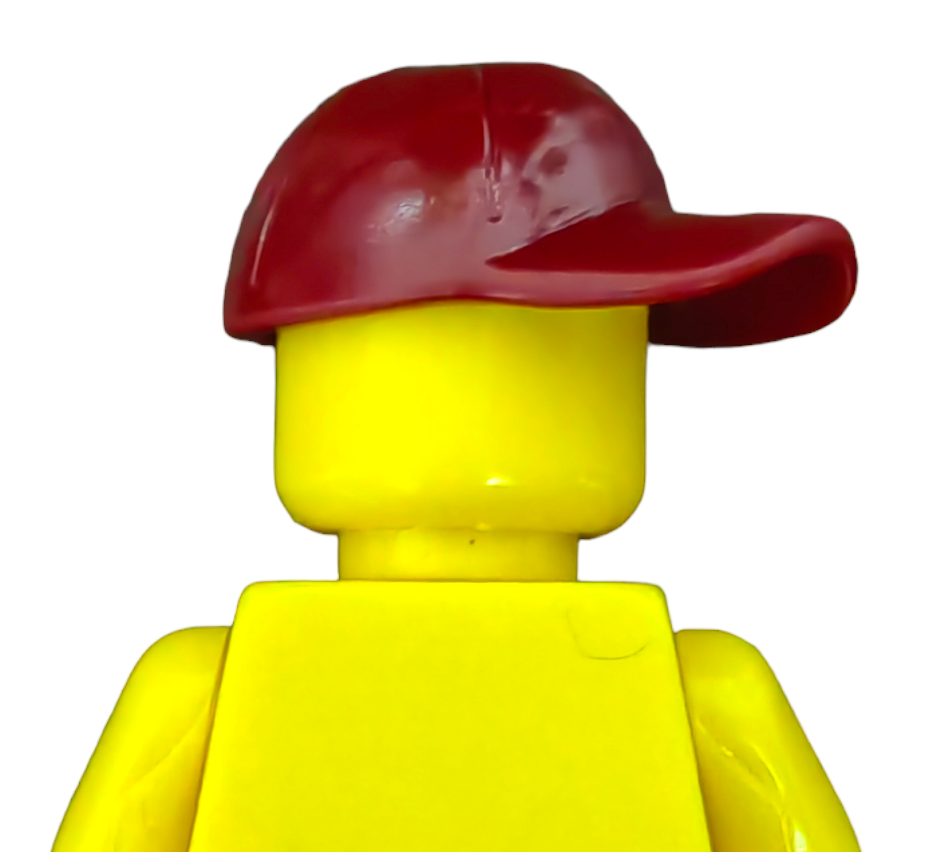 A PRODUCT HATS AND HOODIES yellow LEGO minifigure, sporting a sideways red baseball cap, stands on a plain white background with no facial details or other features visible.