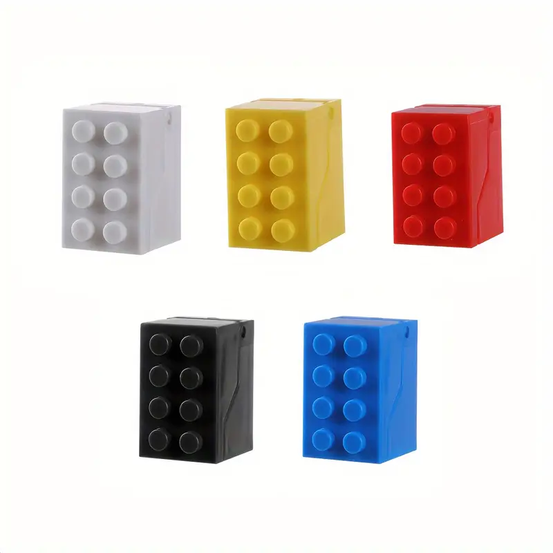 Five stackable toy blocks in vibrant white, yellow, red, black, and blue with a 2x3 pattern of circular protrusions on top are reminiscent of the Kids Childrens Toothbrush Holder Wall-Mounted Brick Blocks Style and are displayed on a plain white background.