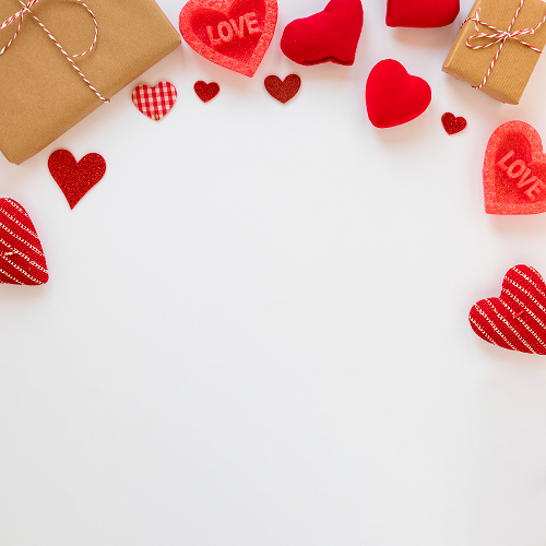 A flat lay featuring LOVE BACKGROUNDS with small red hearts and brown gift boxes tied with red and white twine on a white backdrop. This heart-filled border leaves space at the center, featuring some hearts with LOVE inscribed on them.